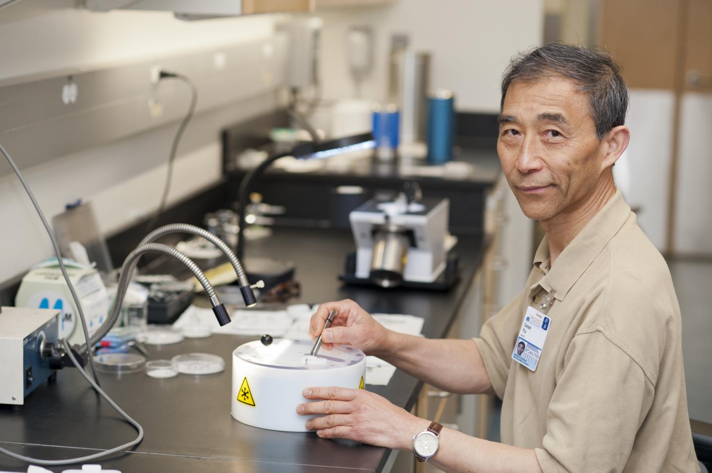 Xiong (Sean) Yu, Ph.D., demonstrates a step in the process of prepping a sample for analysis. image: Kay Taylor | University of Virginia Health System